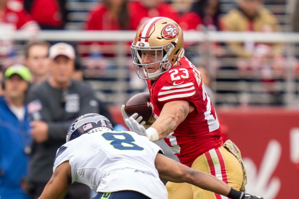 San Francisco 49ers running back Christian McCaffrey (23) runs against Seattle Seahawks cornerback Coby Bryant (8) during the second quarter at Levi's Stadium. Kyle Terada-Imagn Images