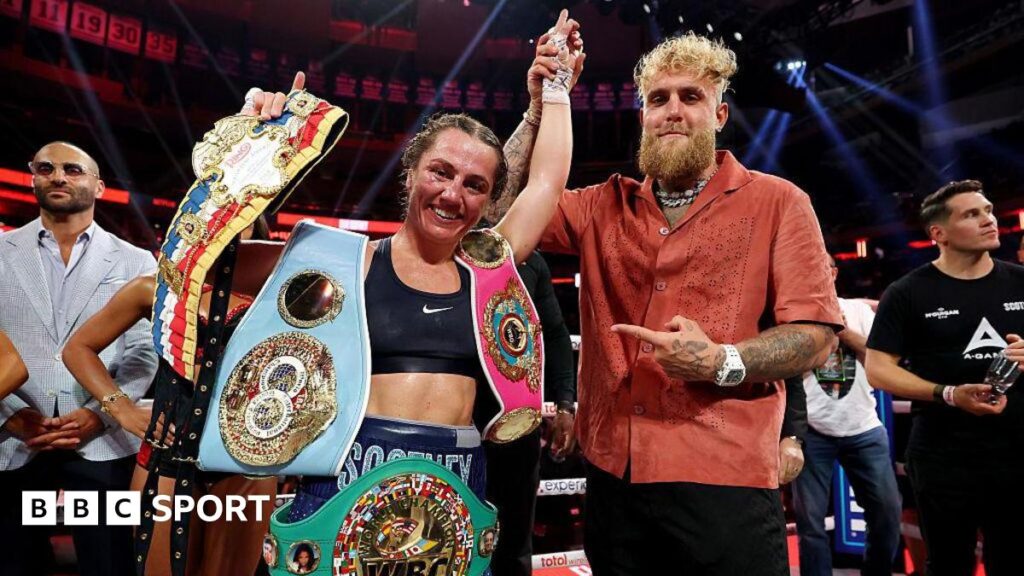 Ellie Scotney having her hand raised by Jake Paul