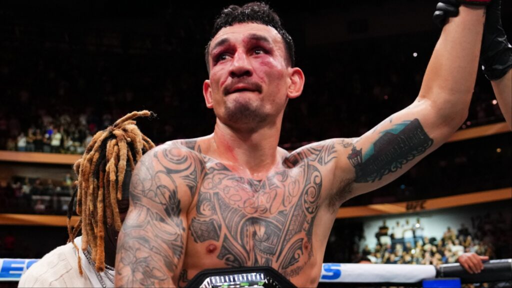 Max Holloway celebrates after his win over Dustin Poirier at UFC 318