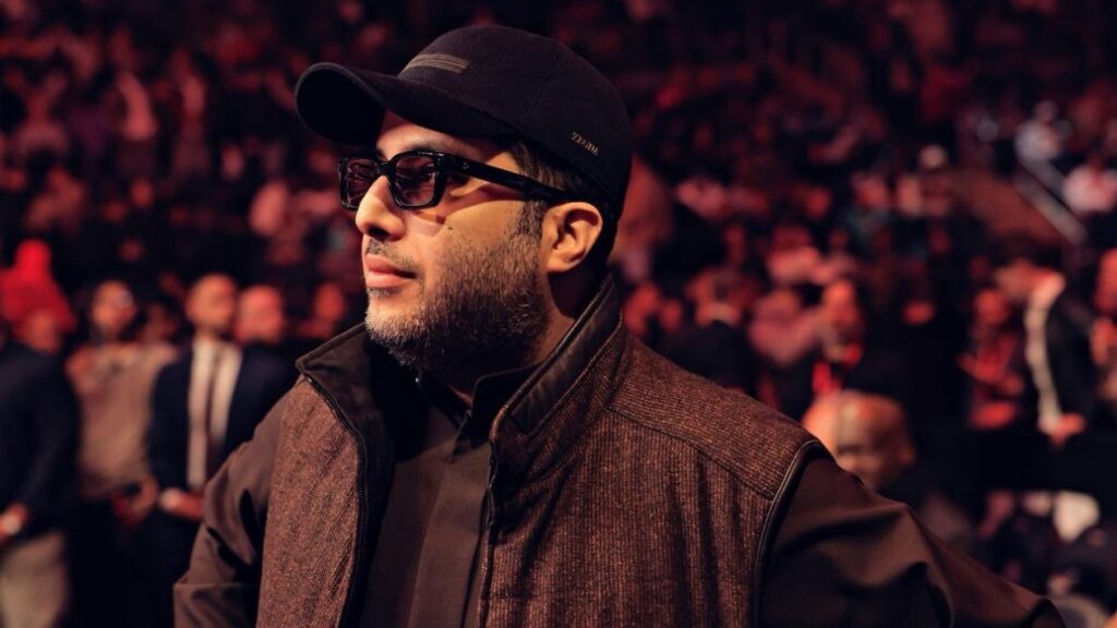 Turki Alalshikh Heel Turn Signals Promoter Power Realignment Across Boxing Turki Alalshikh attends a major boxing event, standing ringside in front of a packed arena crowd.