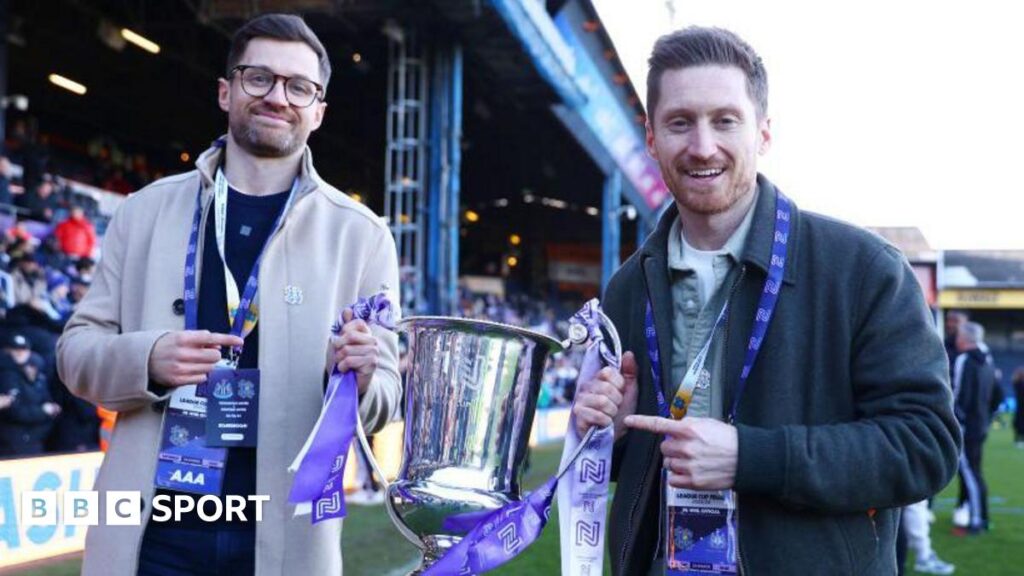 Spencer Owen, Founder and Chairman of Hashtag United, and Seb Carmichael-Brown, Founder and Commercial Director of Hashtag United, pose for a photo with the FA Women's National League Cup trophy after their team's victory the FA Women's National League Cup Final between Newcastle United and Hashtag United at Kenilworth Road