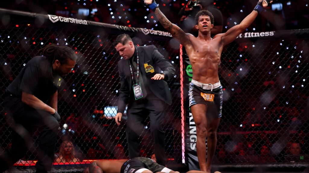 Adriano Moraes celebrates after submitting Phumi Nkuta as referee Herb Dean intervenes